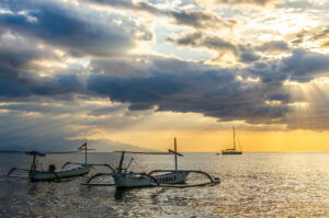 Sunrise at Lovina Beach Bali Dolphin Tours with dolphins jumping in the ocean
