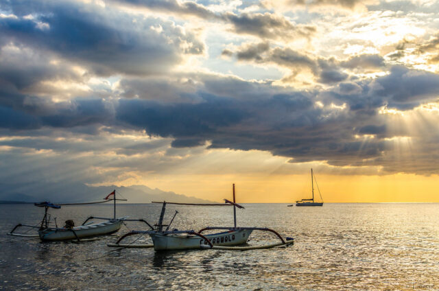 Sunrise at Lovina Beach Bali Dolphin Tours with dolphins jumping in the ocean